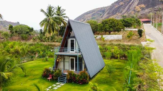 A beautiful luxury farmhouse nestled in a lush green managed farmland estate near Bangalore.